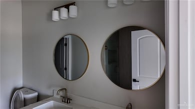 Full bathroom featuring toilet and vanity