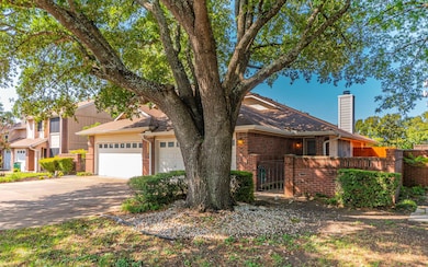 View of front of property with brick siding, driv