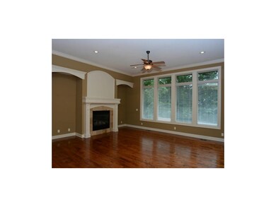 Spacious living room with fireplace and hardwood f