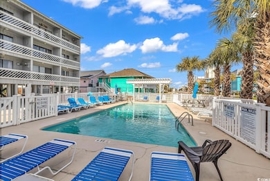 Pool featuring a patio and fence