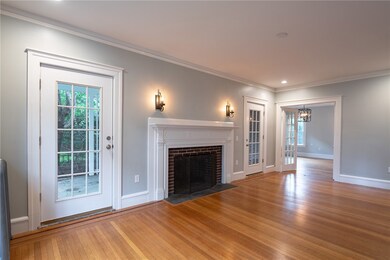 Living room with oversized fireplace, leading to c