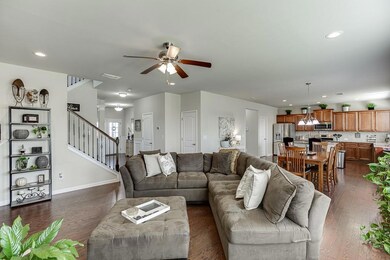 Living area featuring stairway, dark wood-type flo