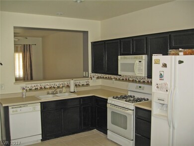 Kitchen with brand new tile floors. Refrigerator s