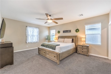 Bedroom with light carpet, baseboards, and ceiling
