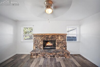 Large living room with wood burning fireplace.