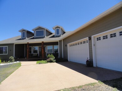 View of the home, & 3 car garage