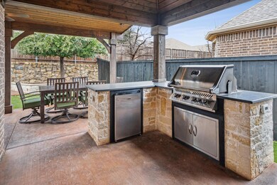 The backyard oasis is the crown jewel of this home with a spectacular custom outdoor living area consisting of an oversized covered patio, an outdoor kitchen, a hot tub, and a low maintenance backyard with artificial turf and a drainage system undern