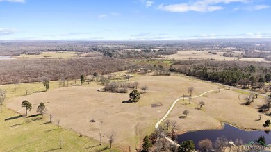 Birds eye view of property with a water view and a