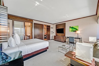 Bedroom with crown molding and carpet