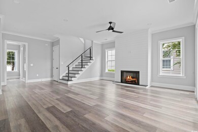 Unfurnished living room featuring a fireplace, orn