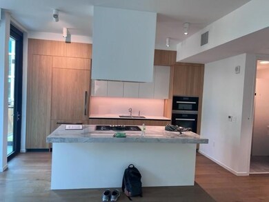 Kitchen featuring dobule oven black, wood finishe