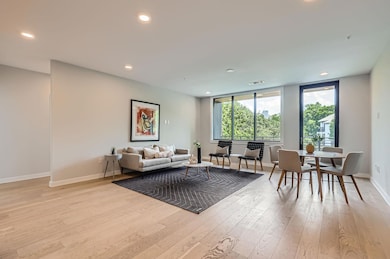 Living area featuring light wood-style floors, ba