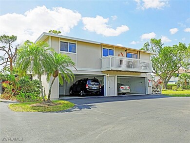 View of front of house featuring asphalt driveway