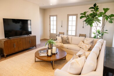 Living room featuring light wood-style flooring and baseboards