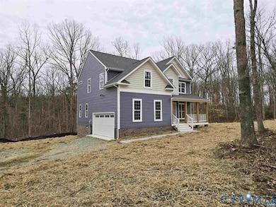 Traditional home with driveway, an attached garage, and covered porch