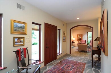The entry offers two large windows and heated flag