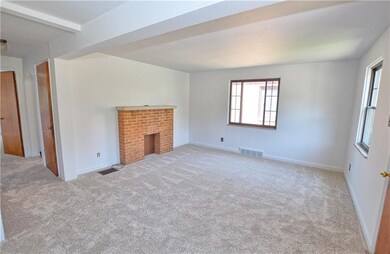 Very large living room with decorative fireplace. 