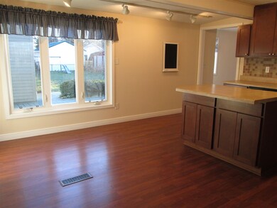 Kitchen showing large window overlooking back yard