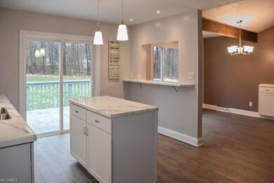The kitchen has a center island, breakfast bar and