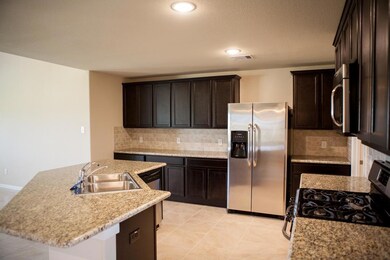 Stainless steel appliances, granite counters accent this kitchen
