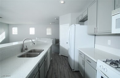 Kitchen with a sink, white appliances, dark wood-s