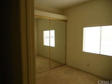 Guest Bedroom with Mirrored Wardrobe Doors.