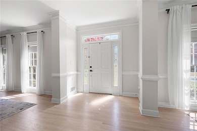 Foyer with baseboards, light wood-type flooring, c