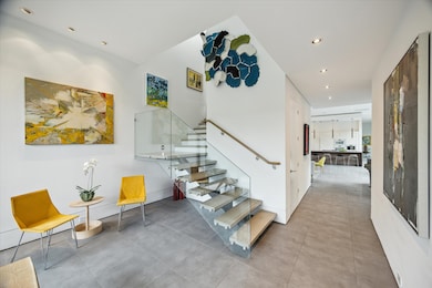 Frameless glass railing with wood floating stairs.