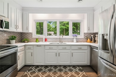 Kitchen with stainless steel appliances, white cab