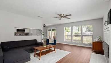 Living room featuring ceiling fan, wood finished 