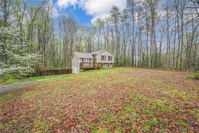 View of front facade featuring a wooded view, a fr