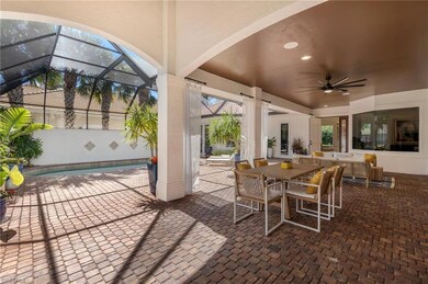 View of patio featuring glass enclosure, outdoor d
