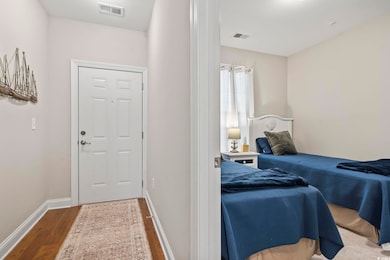 Bedroom with hardwood / wood-style floors and a cl