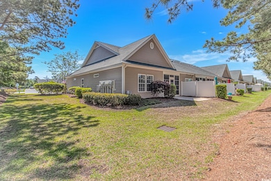 View of side of property with a lawn, a shingled r