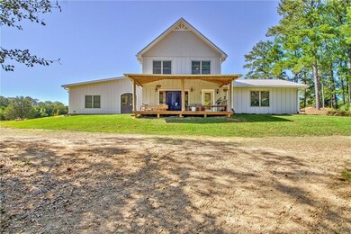 Back of property featuring a lawn and a porch