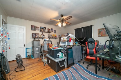 Home office with wood finished floors and ceiling fan