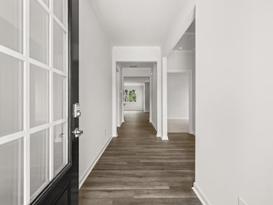 Aria front entryway into foyer with additional bedroom and bathroom to the right