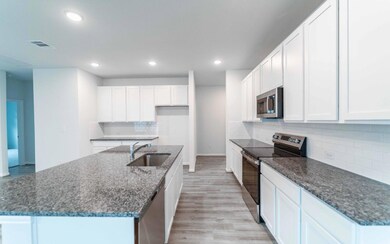 Kitchen with tasteful backsplash, light wood-styl
