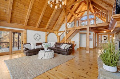 Living room featuring high vaulted ceiling, plenty