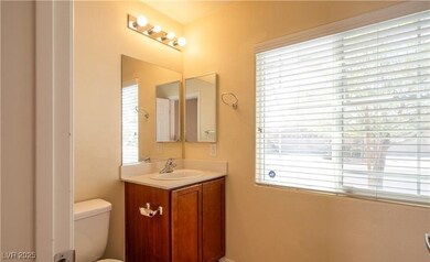 Half bath featuring plenty of natural light, vanit