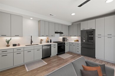 Kitchen featuring fridge with ice dispenser, stai