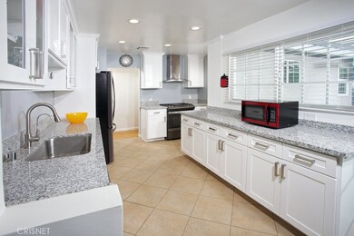 The cook in the family is going to truly appreciate the newly remodeled kitchen with its modern recessed lights, gleaming picture windows, showcase white cabinetry, handy pantry, self/soft-closing drawers and doors, built-in trash/recycling bin, gran