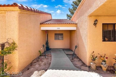 Entrance to property featuring a tile roof and stucco siding