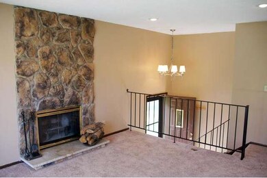 Living room features wood-burning fireplace.