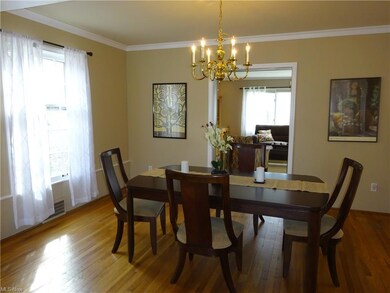 The dining room is spacious and features hardwood 