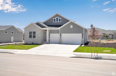 Craftsman-style home with board and batten siding, driveway, and a front yard