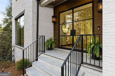 Front entrance through double French steel doors into a two story foyer.