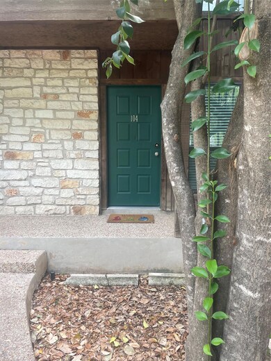 Doorway to property with stone siding