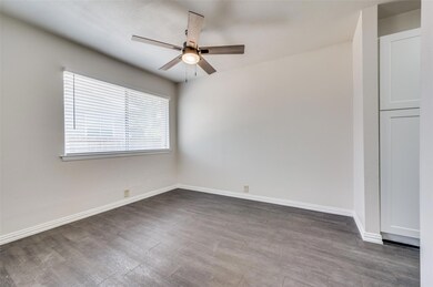 Spare room with ceiling fan and wood-type flooring