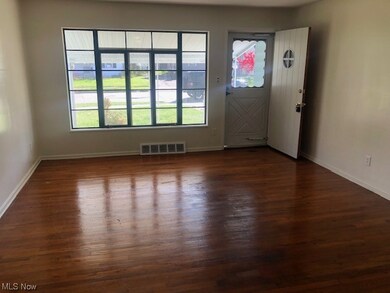 Living room with dark hardwood / wood-style floors